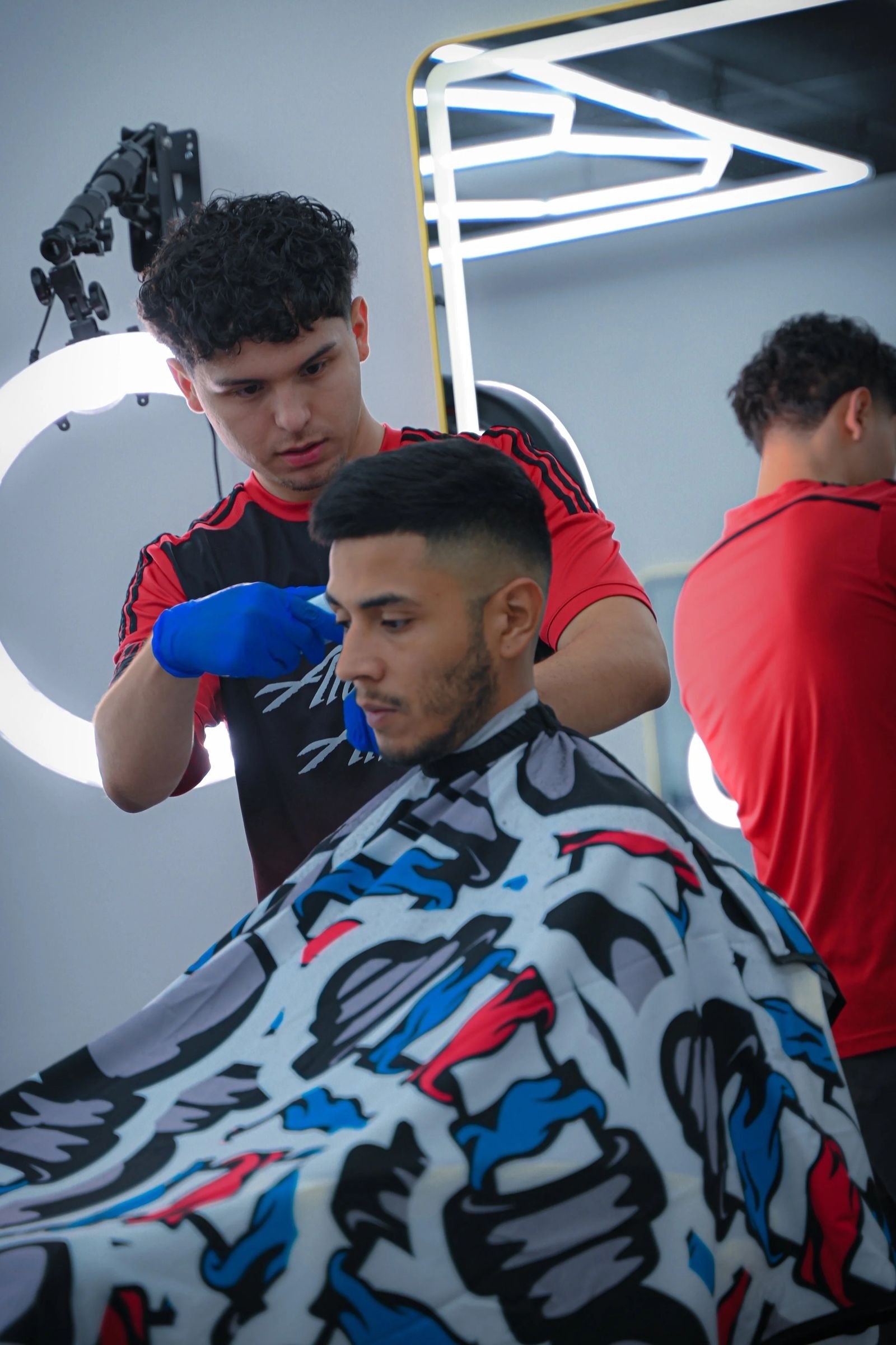 Barber fading a client at Madison Barbershop